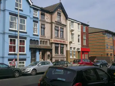 a street with cars parked in front of buildings at Leatham Park Hotel Blackpool in Blackpool