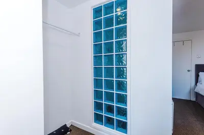 a large window in a room with a bed at Private garden maisonette near city centre! Walking distance from Anfield in Liverpool