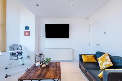 a living room with a couch and a coffee table at Private garden maisonette near city centre! Walking distance from Anfield in Liverpool