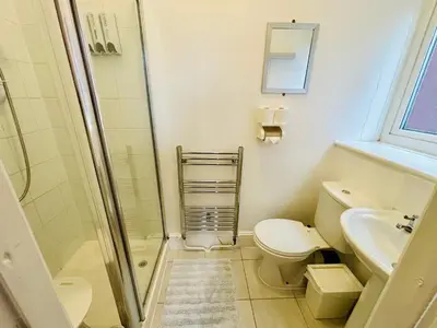 a bathroom with a shower and a toilet and a sink at Le Papillon Hotel Blackpool in Blackpool