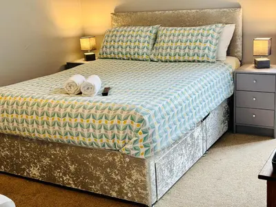 a bedroom with a bed with two towels on it at Le Papillon Hotel Blackpool in Blackpool