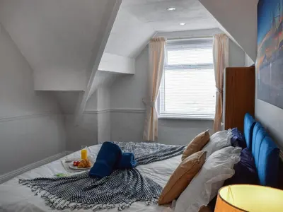a large bed in a room with a window at Drumford in Blackpool