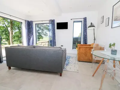 a living room with a couch and a table at Priestleys Retreat in Blackburn