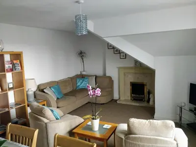 a living room with two couches and a fireplace at The Rafters Bank House Stunning Apartment in Millom