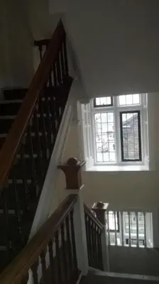 a stairway with a window and a stair case at The Rafters Bank House Stunning Apartment in Millom