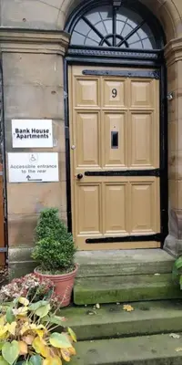 a large wooden door on the side of a building at Estuary View Bank House Stunning apartment in Millom