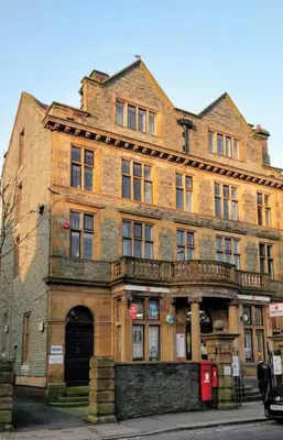 an old brick building on the corner of a street at Estuary View Bank House Stunning apartment in Millom