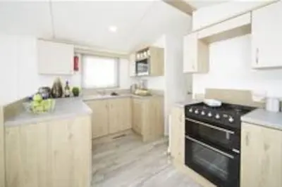 a kitchen with a black stove top oven at Sea breeze, modern, cosy holiday home in Haverigg