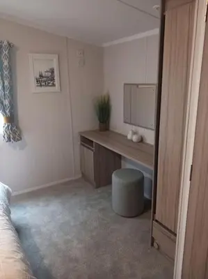 a bedroom with a desk with a television in it at Nadia's Lodge Smart TV & Wi-Fi in Haverigg