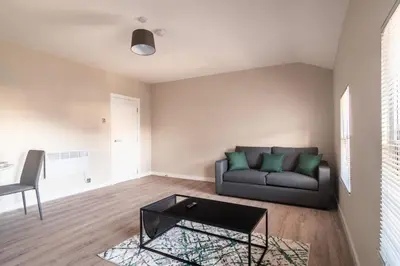 a living room with a couch and a table at Charming 1 Bedroom Apartment in Central Liverpool in Liverpool