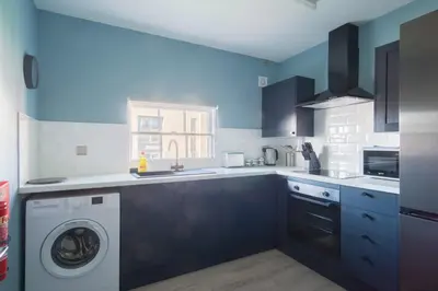a kitchen with a washer and dryer in it at Charming 1 Bedroom Apartment in Central Liverpool in Liverpool