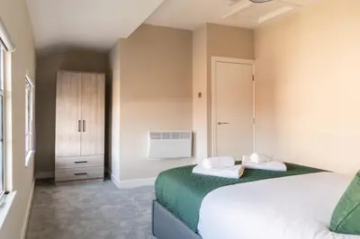 a bedroom with two beds and a closet at Charming 1 Bedroom Apartment in Central Liverpool in Liverpool