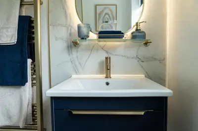 a bathroom with a white sink and a mirror at Peacock Room at Field View Cottage in Eccleston