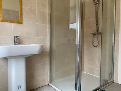 a bathroom with a shower and a sink and a shower at Springfield Guesthouse in Blackburn