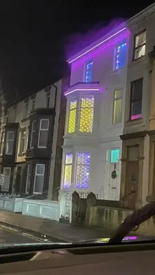 a building with purple and yellow lights on it at Double Room with Private Bathroom Partial Tower view 16 Havelock Street - 5 in Blackpool