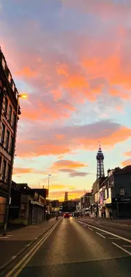 an empty street at sunset with a clock tower at Double Room with Private Bathroom Partial Tower view 16 Havelock Street - 5 in Blackpool