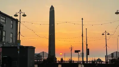 a sunset with the washington monument in the background at Double Room with Private Bathroom Partial Tower view 16 Havelock Street - 5 in Blackpool