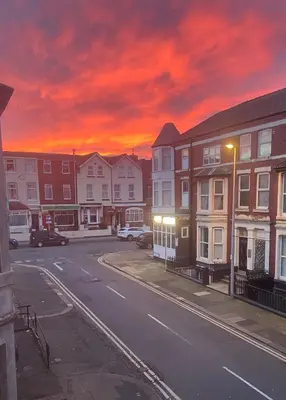 a city street with houses under a red sky at Double Room with Private Bathroom Partial Tower view 16 Havelock Street - 5 in Blackpool