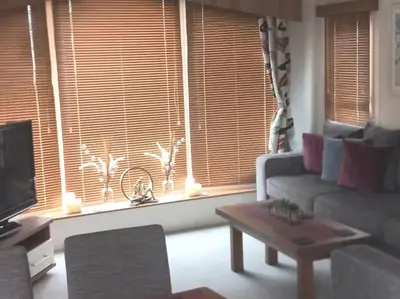 a living room with a couch and a table and a window at Parkview, Port Haverigg in Haverigg