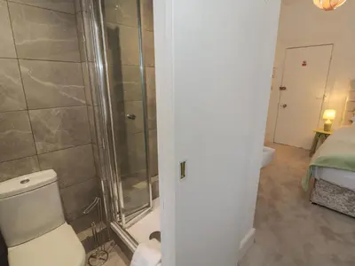 a bathroom with a shower and a toilet in a room at The Furness Haven in Barrow in Furness