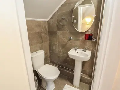 a bathroom with a toilet and a sink at The Furness Haven in Barrow in Furness