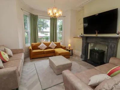 a living room with a couch and a fireplace at The Furness Haven in Barrow in Furness
