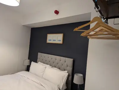 a bedroom with a bed and a black wall at Blok 3 -Jacuzzi Suites, Apartment & Ensuite Rooms in Blackpool