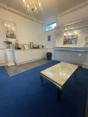 a large room with a table in the middle of it at The New ATLAS HOTEL in Blackpool