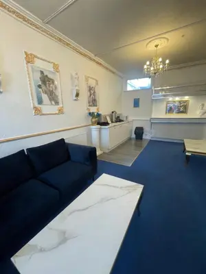 a living room with a couch and a kitchen at The New ATLAS HOTEL in Blackpool