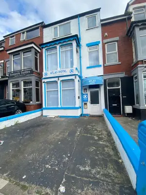 an empty parking lot in front of a building at The New ATLAS HOTEL in Blackpool