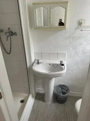 a small bathroom with a sink and a shower at The Stage Door Hotel in Blackpool