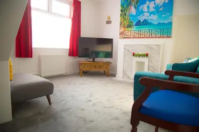 a living room with a couch and a tv at Lucky Home 24 - Ideal for Trade & Family - 2 Bedrooms - 3 Beds - Max 4 Guests - Close to BAE, Docks, Lake District, Beaches in Barrow in Furness