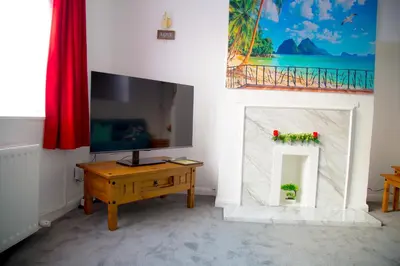 a living room with a tv and a fireplace at Lucky Home 24 - Ideal for Trade & Family - 2 Bedrooms - 3 Beds - Max 4 Guests - Close to BAE, Docks, Lake District, Beaches in Barrow in Furness