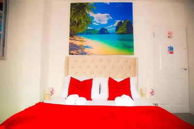 a bedroom with a red bed with red pillows at Lucky Home 24 - Ideal for Trade & Family - 2 Bedrooms - 3 Beds - Max 4 Guests - Close to BAE, Docks, Lake District, Beaches in Barrow in Furness