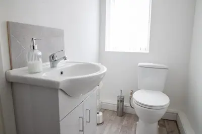 a white bathroom with a sink and a toilet at Ground Floor - Balmoral Stays - Free Wifi in Blackpool
