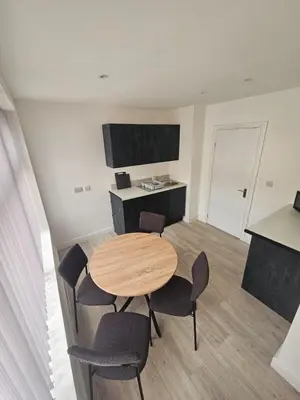 a dining room with a table and chairs in a room at Ground Floor - Balmoral Stays - Free Wifi in Blackpool