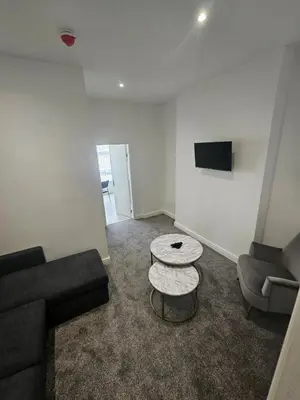 a living room with a couch and a table at Ground Floor - Balmoral Stays - Free Wifi in Blackpool