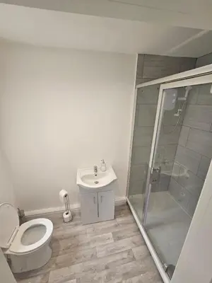 a bathroom with a toilet and a shower and a sink at Ground Floor - Balmoral Stays - Free Wifi in Blackpool