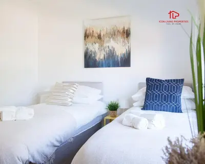two beds sitting next to each other in a room at Spacious 7-Bed Home for Contractors & Families in St Helens in Saint Helens