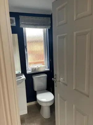 a bathroom with a toilet and a window at Gressingham 9 - South Lakes Leisure Village - lodge on the lake in Carnforth