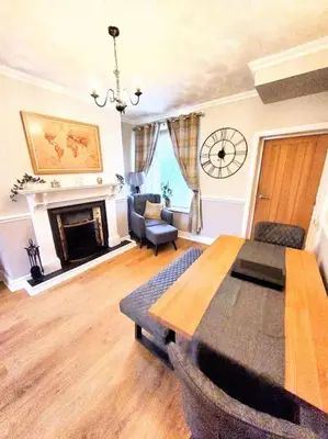 a living room with a table and a fireplace at Quakers Field View in Pennington
