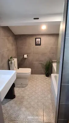 a bathroom with a toilet and a sink and a tub at Quakers Field View in Pennington
