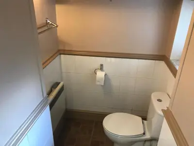 a small bathroom with a toilet in a room at Millbrook by the sea in Wallasey