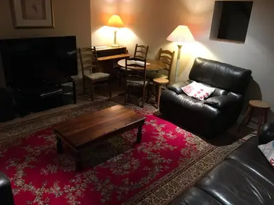 a living room with a leather couch and a coffee table at Millbrook by the sea in Wallasey
