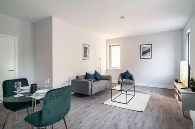 a living room with a couch and a table at Modern 1 Bed Apartment in Waterloo Liverpool in Liverpool