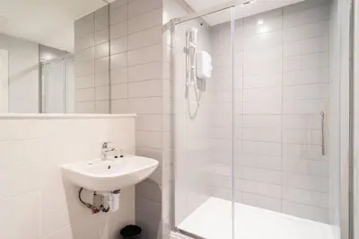 a white bathroom with a sink and a shower at Modern 1 Bed Apartment in Waterloo Liverpool in Liverpool