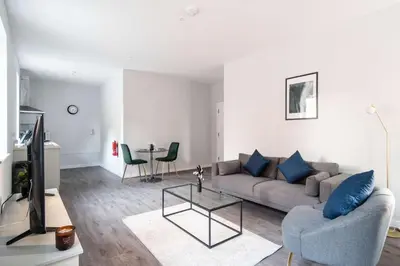 a living room with a couch and a table at Modern 1 Bed Apartment in Waterloo Liverpool in Liverpool