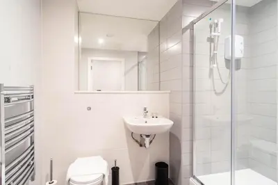 a white bathroom with a sink and a shower at Modern 1 Bed Apartment in Waterloo Liverpool in Liverpool