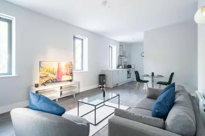 a living room with two couches and a table at Modern 1 Bed Apartment in Waterloo Liverpool in Liverpool