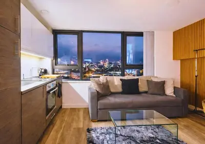 a living room with a couch and a large window at Stylish City Escape near Cavern Quarter sleeps 4 in Liverpool
